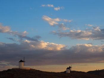 Silhouette lighthouse against sky during sunset