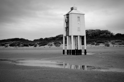 Lifeguard hut on beach against sky