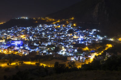 High angle view of illuminated buildings in city at night