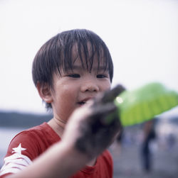 Close-up of cute boy holding toy