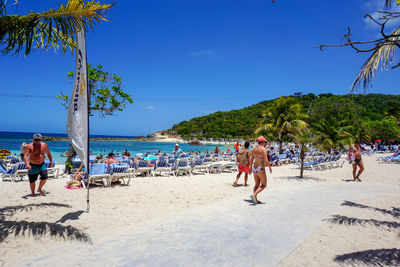 People at beach against sky