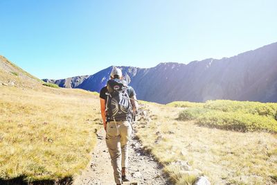 Rear view of man standing on mountain