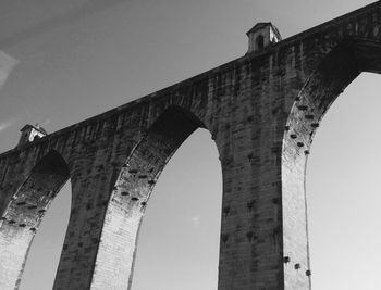 Low angle view of arch bridge against clear sky