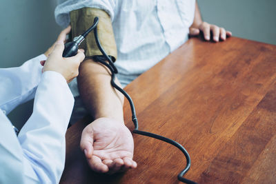 Low section of man and woman sitting on table