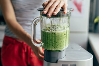 Close-up blender process. cooking a green evening smoothie. mixing in a blender bowl.