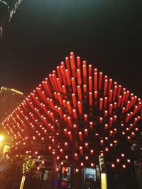 Low angle view of illuminated buildings against clear sky at night