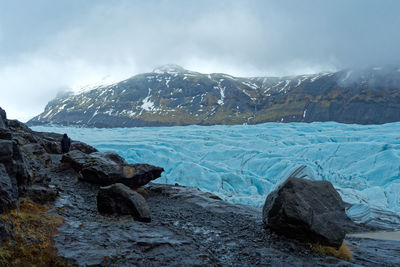 Scenic view of snowcapped mountains against sky