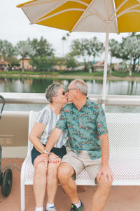 Couple sitting on swimming pool