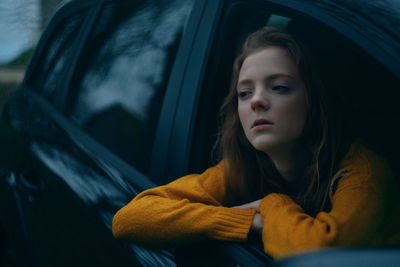 Portrait of teenage girl sitting in car