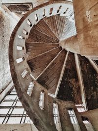 Low angle view of old wheel against wall