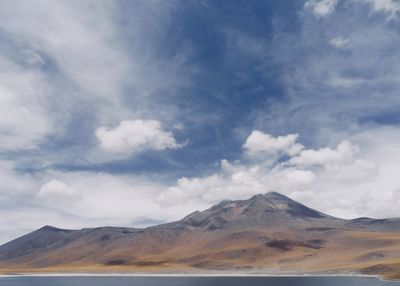 View of volcanic landscape against cloudy sky