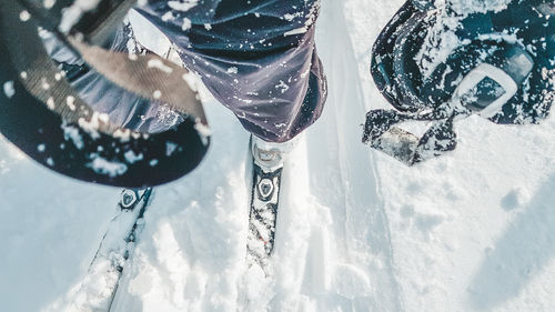 Low section of  person skiing on snow powder 