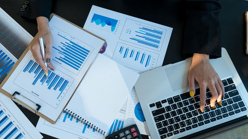 Tilt image of people working on table