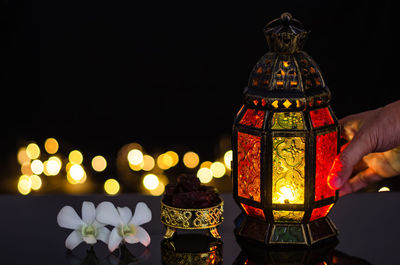 Lantern and dates fruit with white orchid flower for the muslim feast of ramadan kareem.