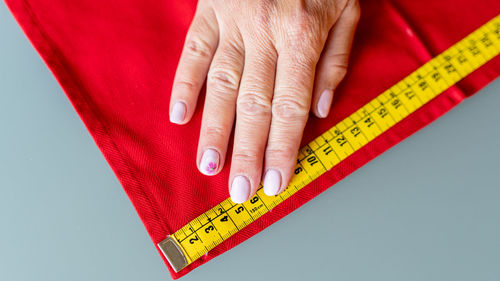 Midsection of woman with tattoo on hand