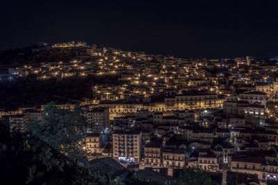 High angle shot of illuminated cityscape against sky at night