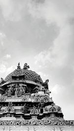 Low angle view of temple against cloudy sky