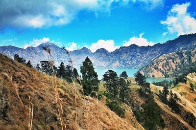 Scenic view of mountains against cloudy sky