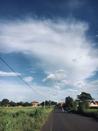 Road amidst plants against sky