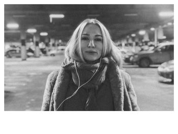 Portrait of young woman with arms raised