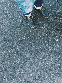 Low section of man standing on road