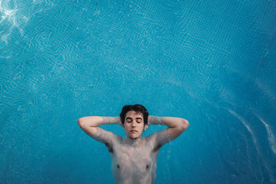 Portrait of a young man swimming in pool