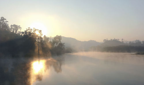 Scenic view of lake against sky during sunset