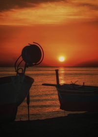 Scenic view of sea against orange sky