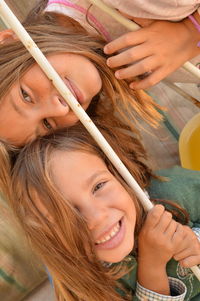 Close-up portrait of smiling girl holding hands