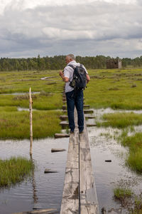 Rear view of woman standing on field