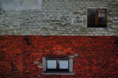 Low angle view of window on brick wall of building