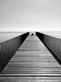 View of pier on sea against clear sky