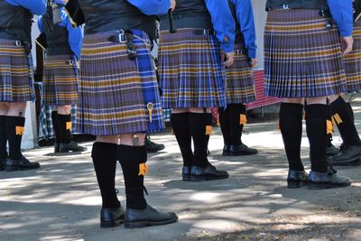 Low section of girls in uniforms standing on road