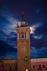 Low angle view of clock tower against cloudy sky
