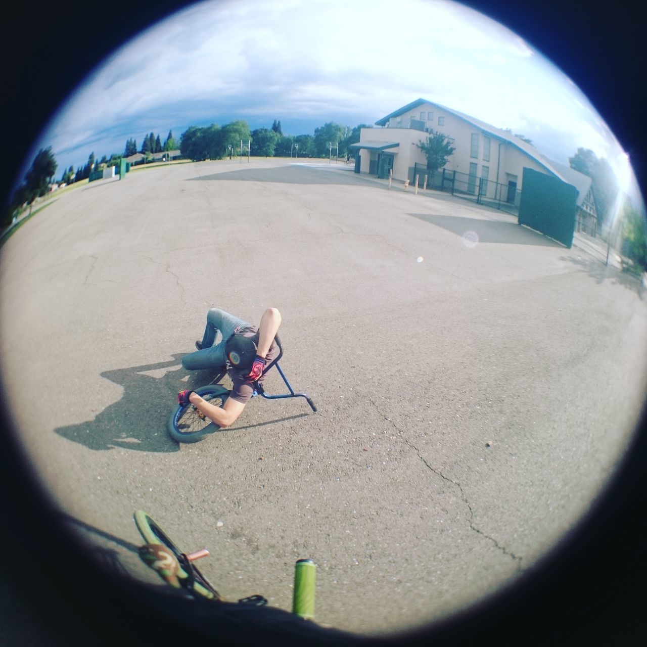 sky, leisure activity, lifestyles, day, circle, fish-eye lens, childhood, sport, field, outdoors, sand, vignette, architecture, built structure, full length, cloud - sky, toy, mid-air