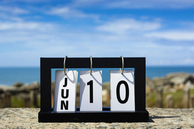 Jun 10 calendar date text on wooden frame with blurred background of ocean. calendar date concept.