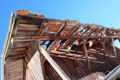 Low angle view of old building against clear blue sky