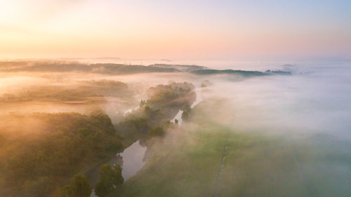 Summer nature landscape aerial panorama. morning fog over river, meadow and forest. nature sunlight 