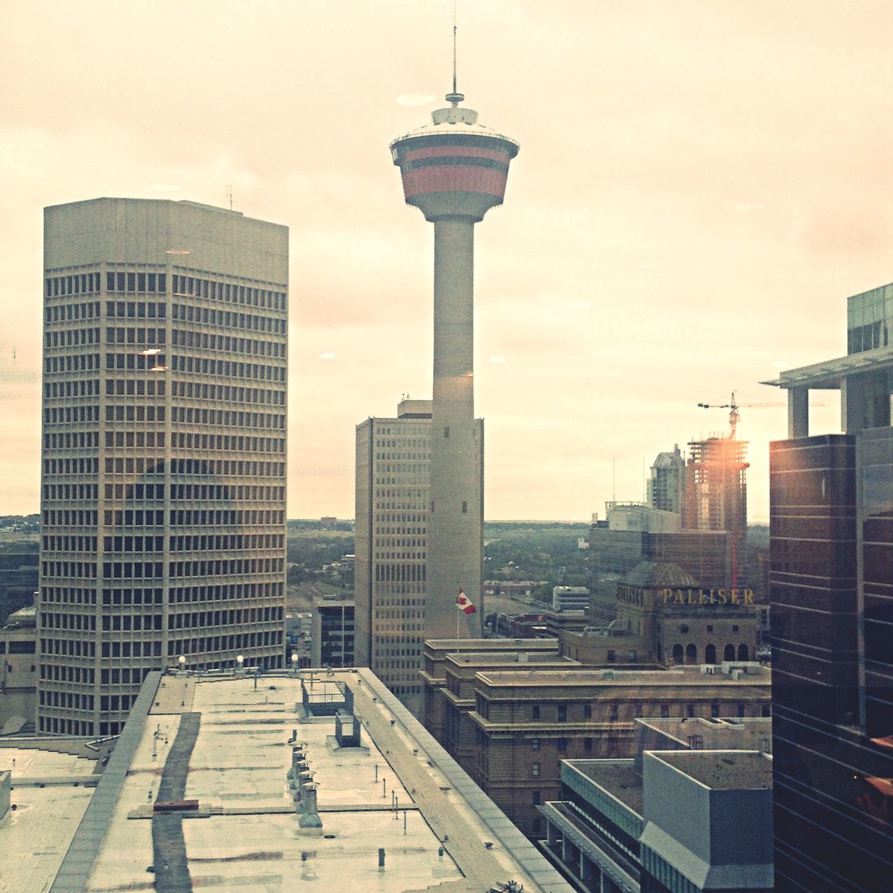 architecture, built structure, building exterior, sky, city, tower, tall - high, sunset, cloud - sky, railing, skyscraper, building, modern, travel destinations, cityscape, city life, outdoors, street light, capital cities, low angle view