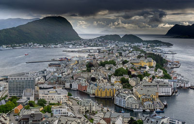 High angle view of townscape by sea against sky