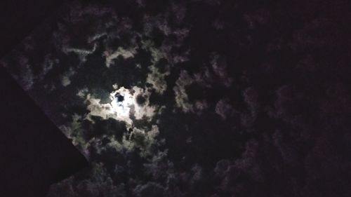 Low angle view of silhouette moon against sky at night