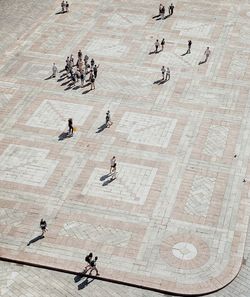 High angle view of people walking on floor square italian 