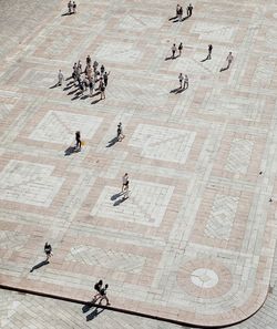 High angle view of people walking on floor