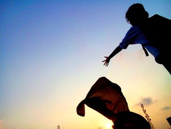 Low angle view of woman against sky