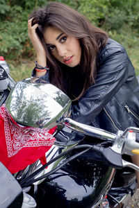 Portrait of young woman sitting on motorcycle