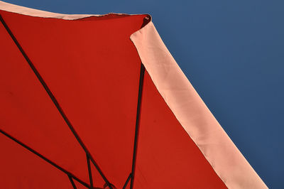 Red parasol against a blue sky