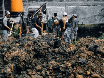 Group of people working on rock