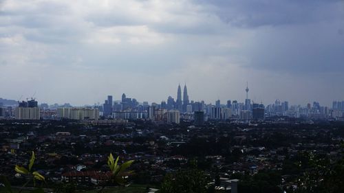 Cityscape against cloudy sky