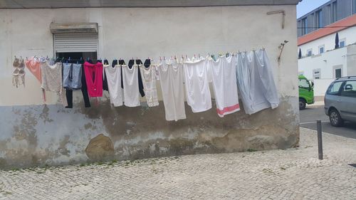 Clothes drying on clothesline in front of building