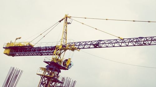 Low angle view of crane against clear sky